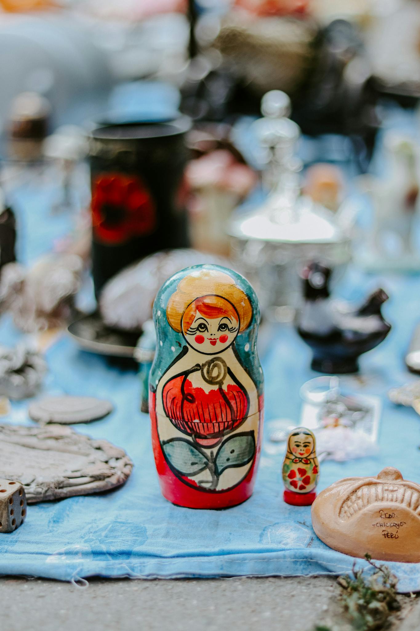 Close-up of colorful traditional Russian matryoshka dolls at a flea market.