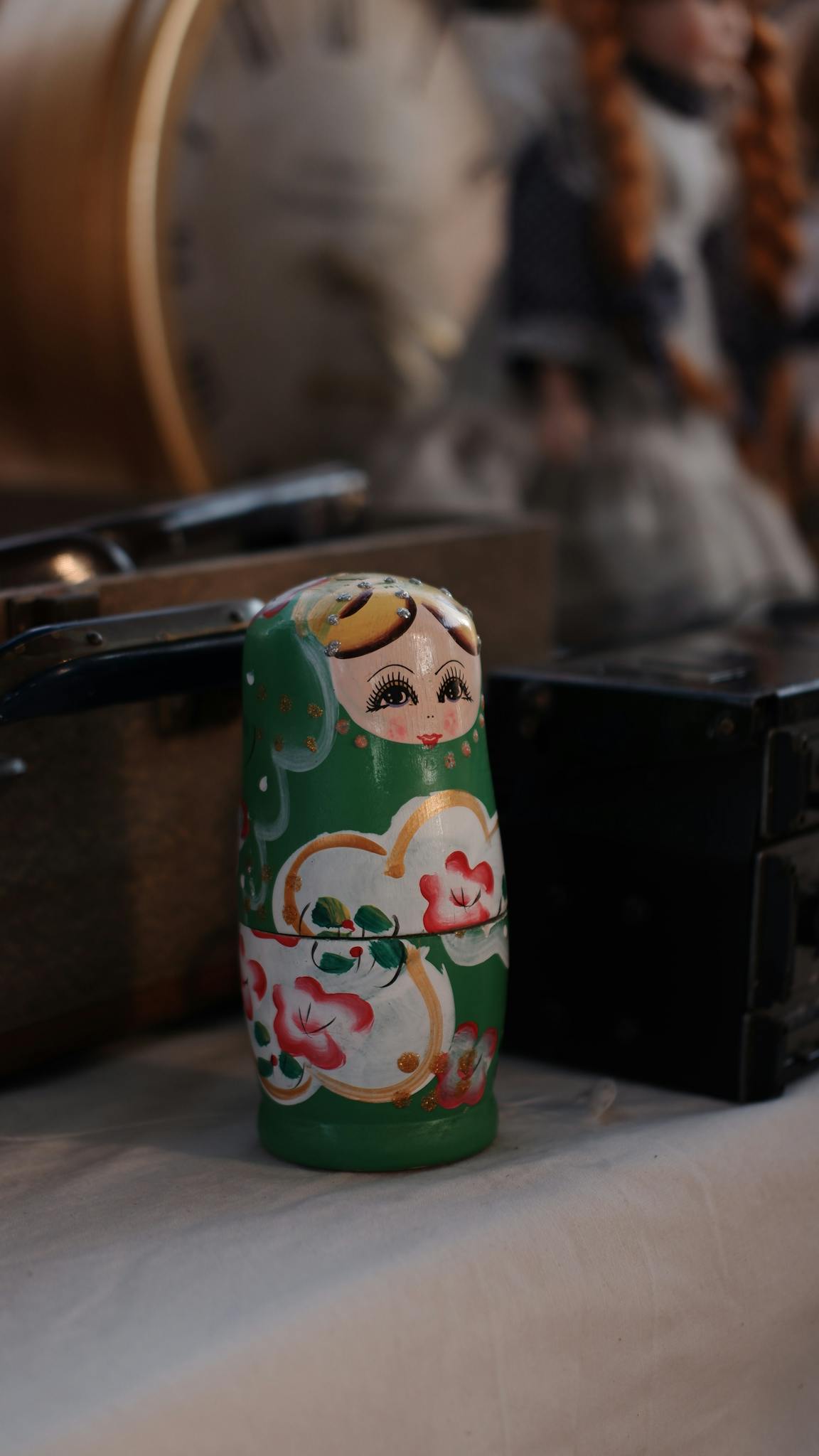 Green Matryoshka doll displayed with vintage items for a classic look.
